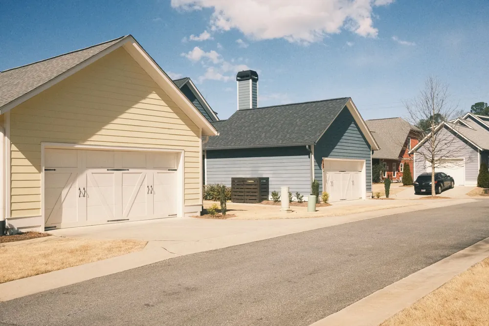 Suburban homes with attached garages and shingle roofs