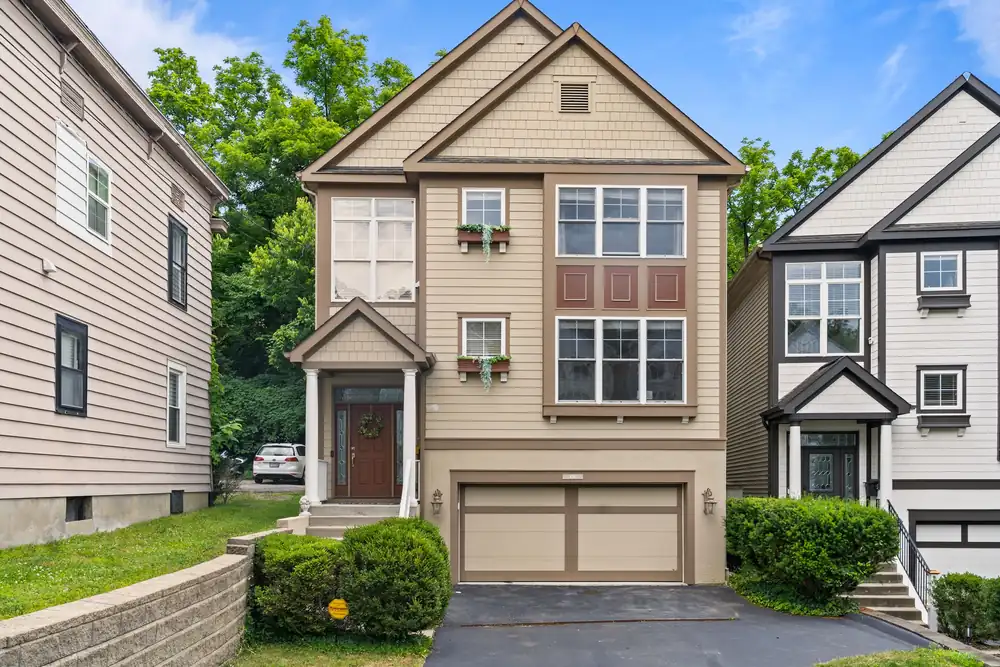 Two-storey home with an asphalt shingle roof and attached garage