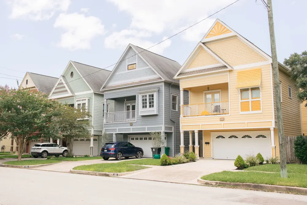 Residential street of homes with pitched asphalt shingle roofs
