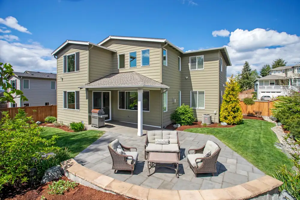Concrete patio and walkway in a landscaped residential back yard